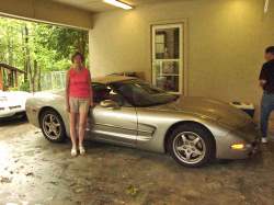 Gloria with "our" Corvette.  The photobomber to the right is Larry (it's his Corvette).