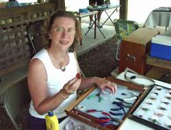 Gloria demonstrating wire wrapping at the club show at Tannehill State Park on June 4.