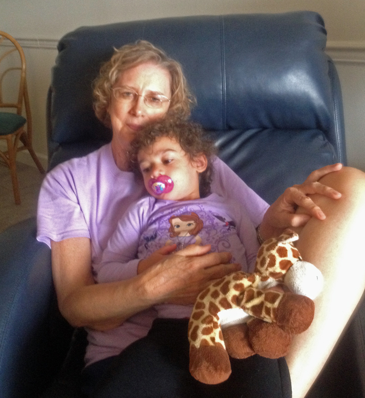 Gloria with sleeping granddaughter H.