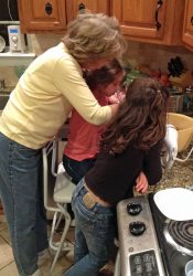 Gloria teaching the girls how to cook.