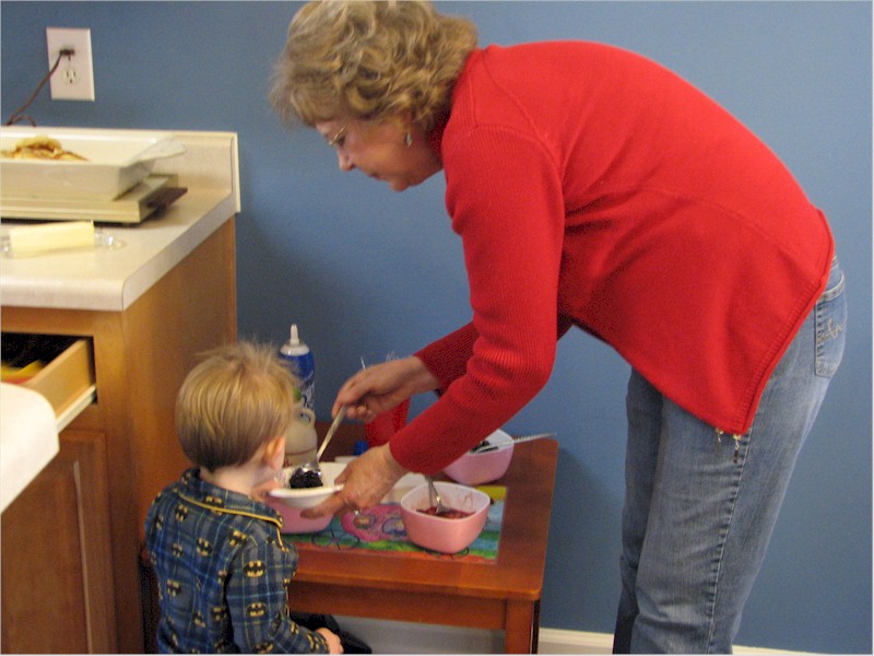 Showing grandson A what's good in his bowl.