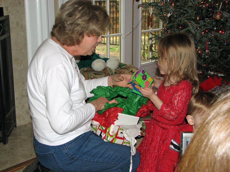 Helping granddaughter C open her present.