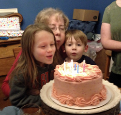 Helping Gloria blow out her candles.